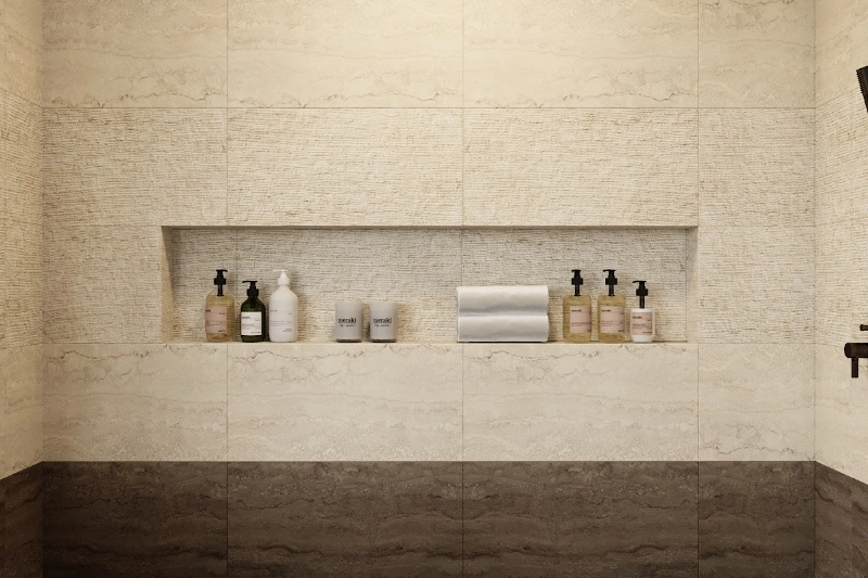 A luxury home remodeling project showcases a shower alcove with a variety of shampoo and soap bottles, all set against elegant beige and brown tiled walls.