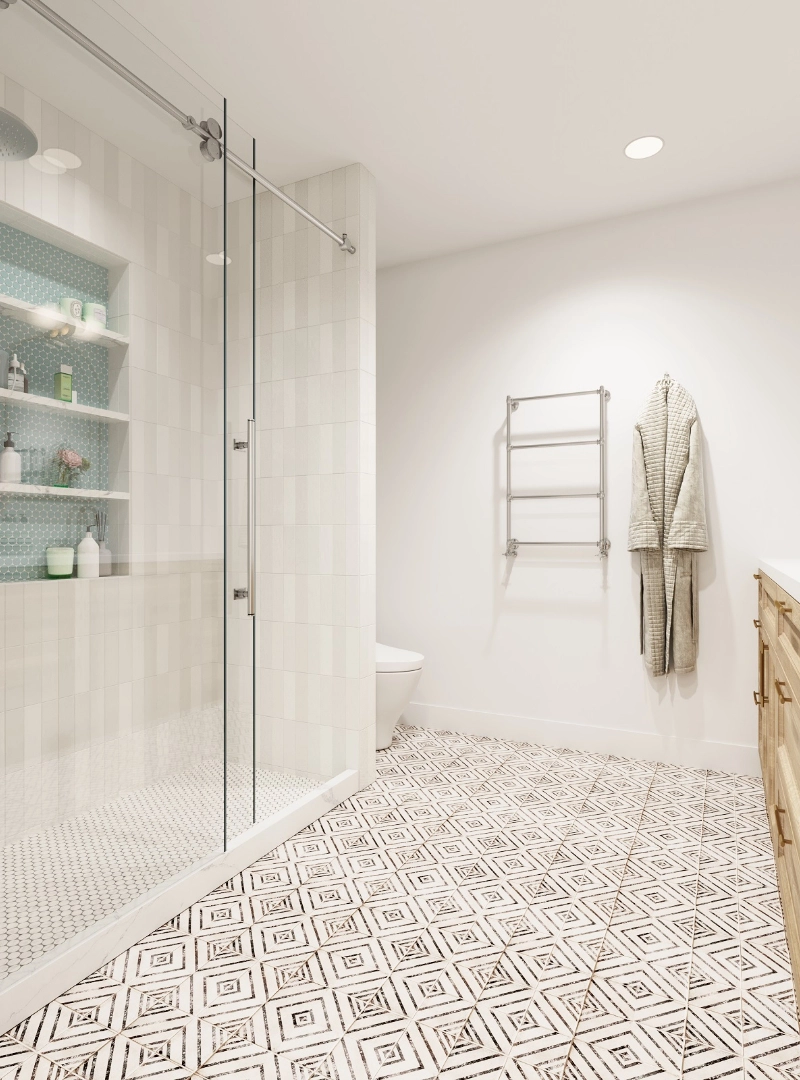Modern bathroom with patterned tile floor, glass-enclosed shower featuring built-in shelving, white walls, a silver towel rack, and a wooden vanity.