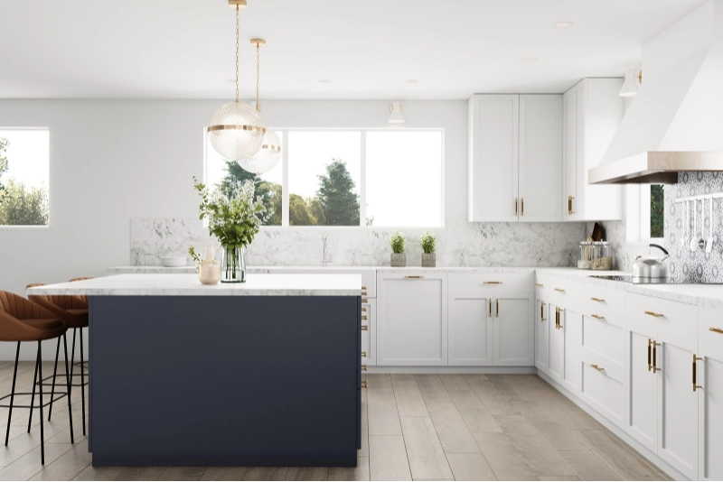 A luxury home remodel reveals a modern kitchen with white cabinets, a dark blue island, marble countertops, gold accents, and wood flooring.