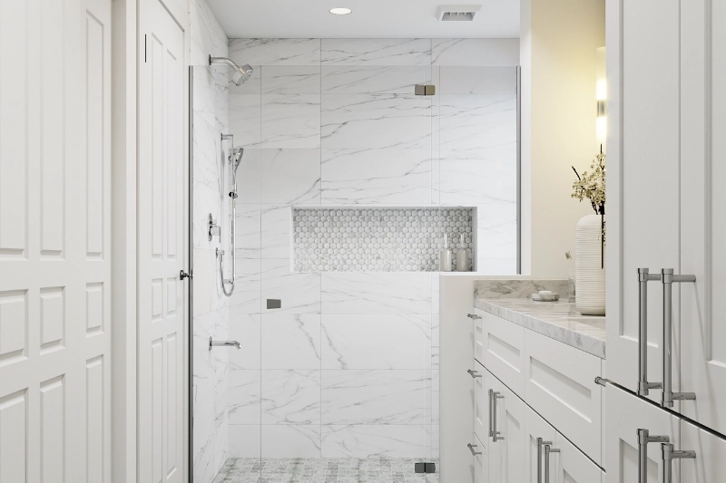 A modern Regency bathroom remodel showcases white marble walls and shower, built-in shelving, a marble countertop, dual sinks, and pristine white cabinetry.